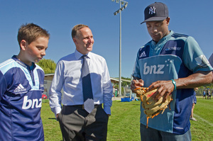 John Key, shown with Max and NY Yankees player Curtis Granderson, will watch his son play in the US. Photo / David Rowland
