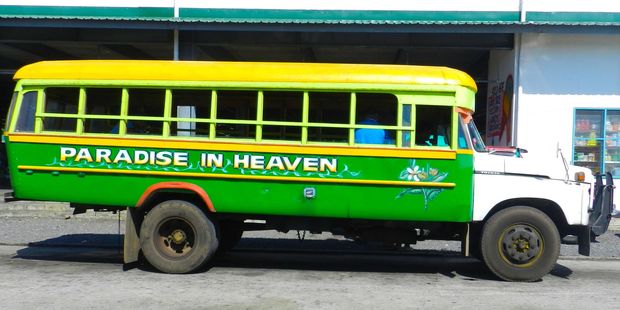 One of the many brightly painted buses of Samoa. Photo / Dan Ahwa
