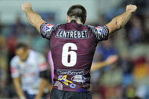 Kieran Foran raises his arms in celebration after his side beat the Cowboys. Source / Getty Images