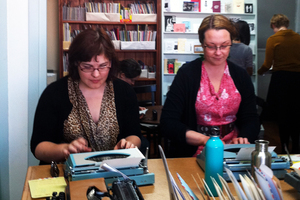 Letter writers using typewriters and rubber stamps, at Alphabet City in Mt Eden. Photo / Richard Robinson
