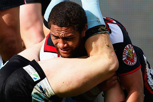 Manu Vatuvei of the Warriors is caught between the legs of Nathan Stapleton of the Sharks during the round 22 NRL match. Photo / Getty Images.