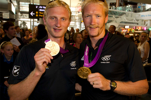 L-R: Hamish Bond and Eric Murray greet fans at Auckland International Airport. The second wave of the Olympic winners to arrive at Auckland International Airport this morning. Photo / Steven McNicholl