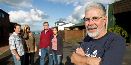 Mike Sadler (front) and fellow Manly Esplanade residents are upset over the rates they're being changed for their Browns Bay homes. Photo / Steven McNicholl