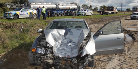 John Robinson's Mitsubishi was badly damaged on the road from Tauranga to Te Puke when two wheels came off the truck in front of him and hit the car, injuring Mr Robinson's back and legs. Photo / APN