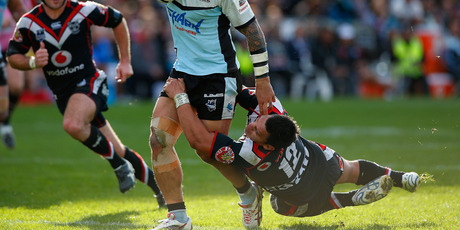 The Warriors' Elijah Taylor tackles Jeremy Smith of the Sharks earlier this month. The defence has been a particular weakness under Brian McClennan. Photo / Getty Images