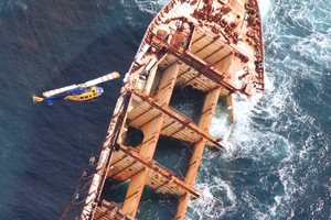 A helicopter and crane barge have started removing pre-cut scrap metal this week. Photo / Supplied