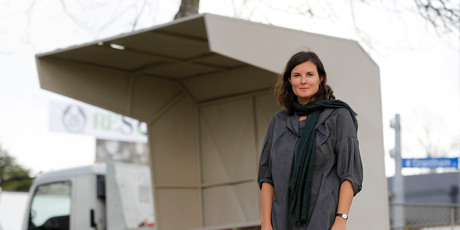 Judge Caterina Riva with the winning entry, a recreation by Michael Parr and Blaine Western of a 1950s Hamilton bus shelter. Photo / Christine Cornege