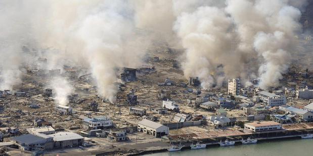 This March 12, 2011 file photo shows smokes rising from burning homes in Yamadamachi in Iwate Prefecture, northern Japan a day after a strong earthquake triggered a devastating tsunami. Photo / AP