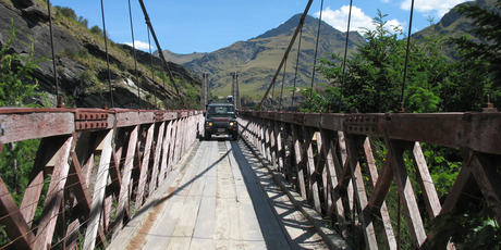 The Skippers Canyon Suspension Bridge is a tight squeeze for the Land Rover. Photo / Paul Rush