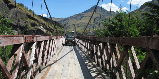 The Skippers Canyon Suspension Bridge is a tight squeeze for the Land Rover. Photo / Paul Rush