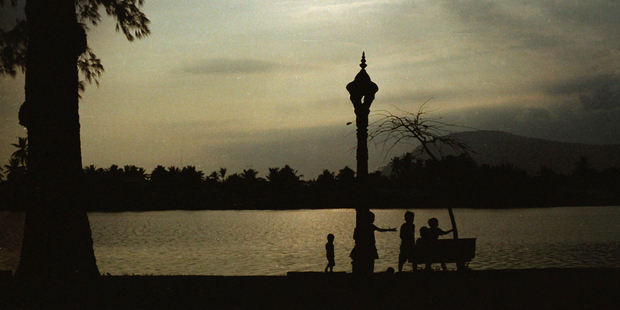 A family relaxes by the river in elegant Kampot, Cambodia. The region is known for its durian (a tropical fruit infamous for its foul smell), seafood, peppercorn, and salt farms. Photo / AAP