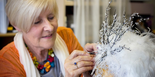 Master milliner Carolyn Gibson adds some finishing touches to one of her creations. Photo / Natalie Slade