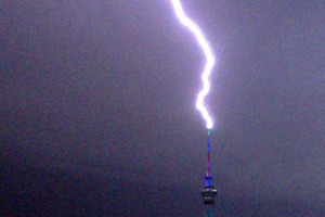 Lightning hits the Sky Tower around 00:45am today, as seen from Freemans Bay. Photo / David Li