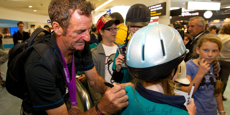 Mark Todd signs autographs as the New Zealand Bronze medal winning Equestrian Team at the 2012 London Olympics arrive back in New Zealand at the Auckland International Airport. Photo / NZ Herald