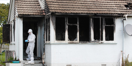 Police investigate the scene of the fatal house fire in Holland Rd where victim Wai Tangi Matenga lived with her children. Photo / Christine Cornege