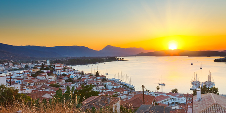 Watching the sun set while sipping beer in Poros, Greece, ranks as one of travel's great pleasures. Photo / Getty Images