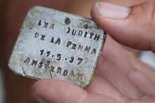 Israeli archaeologist Yoram Haimi shows aluminum plate at the site of the former German Nazi death camp of Sobibor. Photo / AP