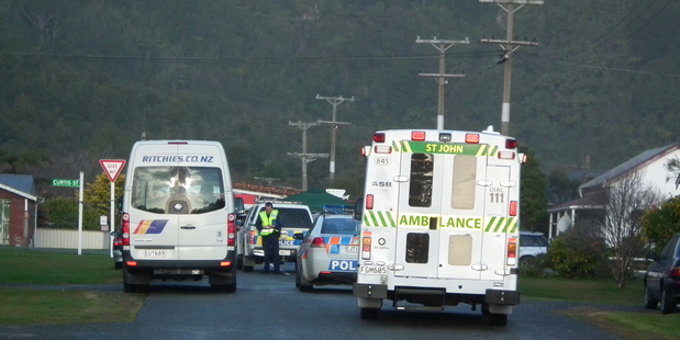 The scene in Hector today after a school bus (left) struck and killed a 5-year-old boy. Photo / Keira Stephenson