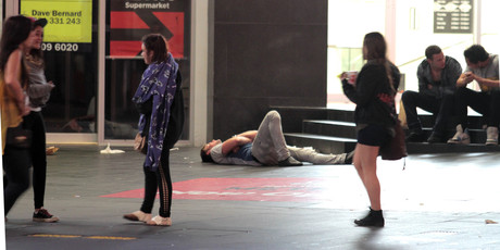 A youth collapses on Queen St in the early hours of the morning. Photo / Geoff Dale