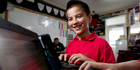 The trust provides cheap computers and internet for children such as Calvin Smith in low-decile schools in Tamaki/Glen Innes. Photo / Sarah Ivey