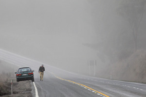 A motorist is surrounded by a cloud of ash on state highway one after Mt Tongariro erupted earlier this month. Photo / Hagen Hopkins