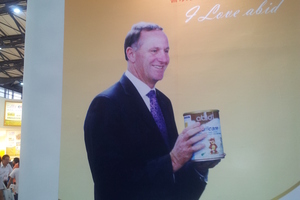 John Key unwittingly endorsing a milk powder formula made by Chinese company abid. Photo / Supplied