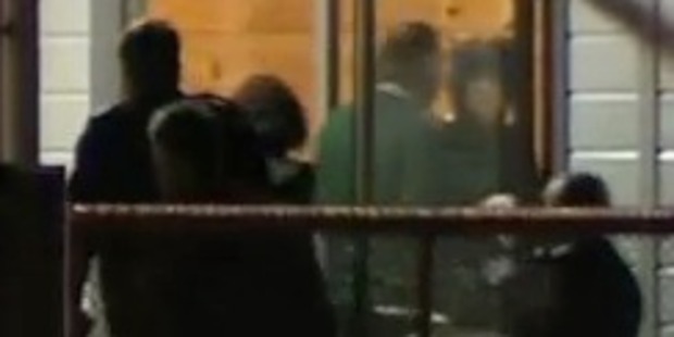 Stewart Murray Wilson (in green) walks into his new home on prison grounds in Wanganui for the first time. Photo / One News