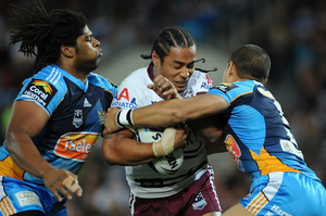 Manly's Steve Matai is wrapped by the Titans defence last night. Photo / Getty Images