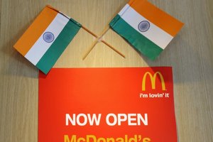 Two Indian flags adorn a sign at a local McDonalds chain restaurant on Independence Day in New Delhi. Photo / AFP