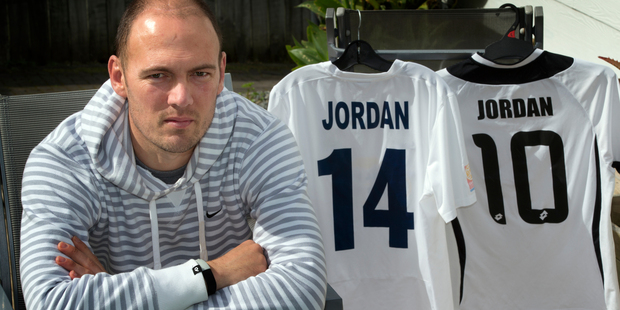 Cancer fighter Keryn Jordan with his old Auckland City playing jersey (left) and son Liam's on the right. Photo / Brett Phibbs