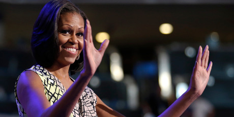 First Lady Michelle Obama waves as she appears at the podium for a camera test ahead of the Democratic National Convention. Photo / AP