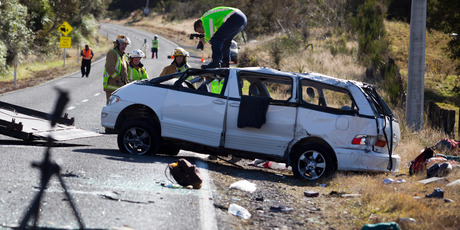Police and fire crews at the crash near Turangi in May that claimed the lives of three American students. Photo / John Cowpland