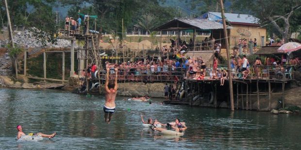 Travellers stop at bars to knock back free shots of potent Lao whisky while tubing down the Nam Song River in Vang Vieng. Photo / Thomas Bishop