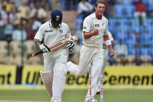 Tim Southee, right, celebrates after taking the wicket of India's batsman Sachin Tendulkar, left, during the fourth day of their second cricket test match in Bangalore. Photo / Getty AP