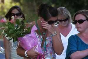 A group of mums from a local school bring floral tributes to the al-Hilli family home in Claygate, England. Photo / Getty