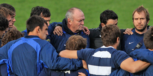 Graham Henry takes part in a team huddle during an Argentina training session. Photo / Getty Images