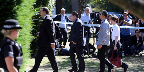 British and French police officers arrive at the home of Saad al-Hilli in England. Photo / AP