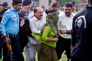 Rimsa Masih is escorted away after being freed on bail. Photo / AP