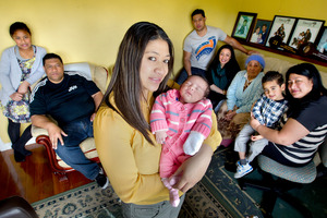 The Anisi family, (from left) Nicola, 10, Moses, Jonathan, 23, Lisa, 21, Emo, Christian, 4, and Kesi. Rebecca and 1-week-old baby Peyton are in front. Photo / Steven McNicholl