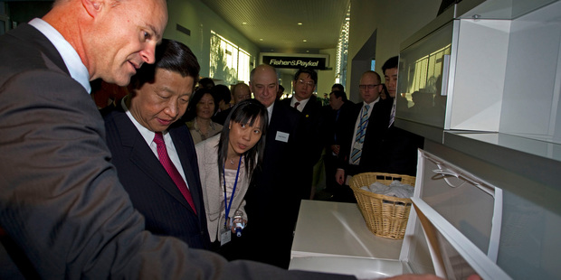 Fisher and Paykel CEO Stuart Broadhurst, left,shows Chinese vice president Xi Jinping around its Auckland factory during a state visit last year. Photo / NZPA