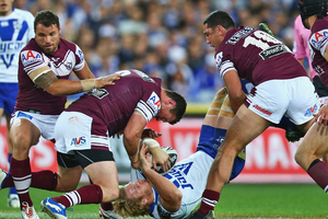 Jason King of the Sea Eagles tackles Bulldogs player Aiden Tolman. Photo / Getty Images