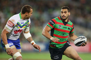 Greg Inglis skips around Blake Ferguson. Photo / Getty Images