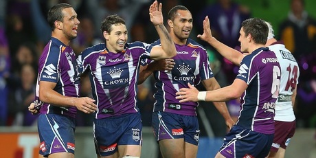 Billy Slater of the Storm is congratulated by team-mates after scoring a try. Photo / Getty Images