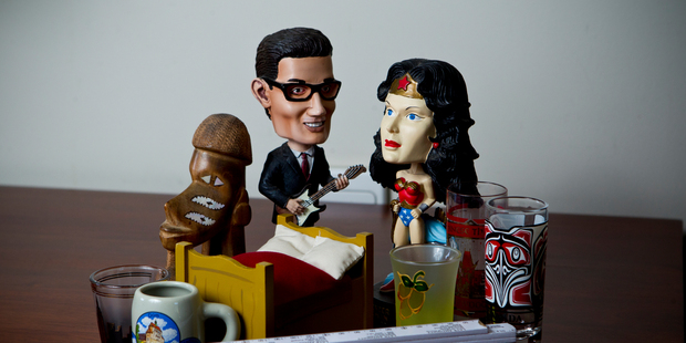 Buddy Holly and Wonder Woman lead the pack of cheap keepsakes collected from travels. Photo / Dean Purcell