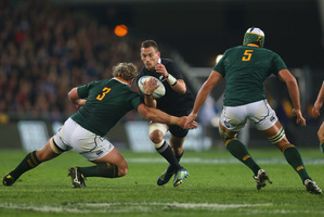Aaron Cruden is tackled by Springbok Jannie Du Plessis during the match in Dunedin. Photo / Getty Images