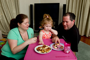 Jessica, Caitlin, 2, and Andrew Miller eat with the TV off. Photo / Steven McNicholl