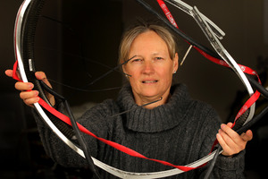 Sirpa Lajunen holds the remains of a bike wheel which was wrapped around her head. Photo / Alan Gibson