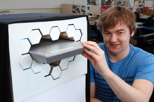 Ben de la Roche demonstrating his revolutionary refrigerator design on a concept model at Massey University's industrial design studio in Wellington. Photo / Mark Mitchell