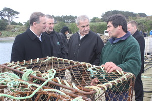 Prime Minister John Key, Chatham Islands general manager Owen Pickles, and Primary Industries Minister David Carter speak to local crayfish fisherman Noel Donaldson. Photo / Supplied