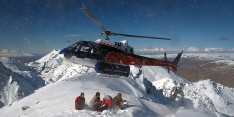 The Harris Mountains Heli-Ski hovers over a mountain peak near Queenstown. Photo / Sarah Ivey